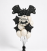 Halloween balloon bouquet with black bat-shaped foil balloons, black star balloons, cream balloons, and a round white balloon reading 'Happy Halloween!' on a black background, displayed on a white studio backdrop.