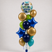 A balloon bouquet featuring a round foil balloon at the top with 'HAPPY BIRTHDAY TO YOU' text, surrounded by metallic gold, navy blue, light green, and teal latex balloons, including two blue star-shaped balloons, set against a plain light gray background.