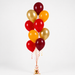 A cluster of party balloons in red, gold, and golden yellow, tied together with a gold base and decorative ribbons on a light gray background.