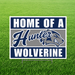 Hunter Wolverines "Home of a Hunter Wolverine" graduation yard sign displayed on a green grass lawn. The square sign features bold navy blue and white text with a gray center stripe, the Hunter script logo, a fierce wolverine mascot graphic, and includes an H-stake for easy yard installation.