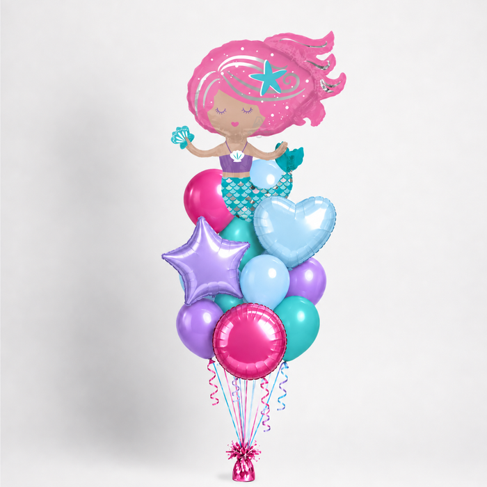 A mermaid-themed balloon bouquet featuring a large pink foil mermaid balloon with a starfish hair accessory, surrounded by pastel pink, blue, purple, and teal latex balloons and a heart, star, and round mylar balloons in similar colors, tied with curling ribbons to a weight against a light gray background.