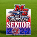 A rectangular Millard South Patriots Senior 2027 sign displayed on a green grass background. The sign features a red, white, and blue patriotic design with the text 'MS Millard South Patriots Senior 2027' and a circular Millard South Patriots logo at the bottom.