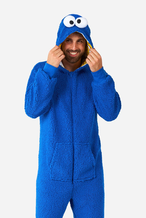 A man wearing an adult Cookie Monster Onsie Costume.