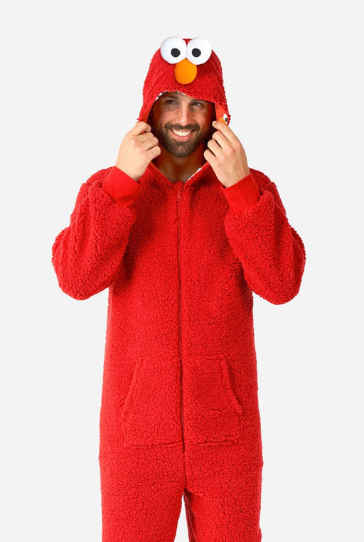 A man wearing and adult Elmo Onesie.