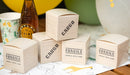 Safari cargo box treat boxes designed like small wooden crates with “Cargo” and “Fragile” printed details on a party table.