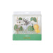 Safari cake topper set with animal picks, green leaves, safari signs, a monkey, zebra, and lion in clear packaging.