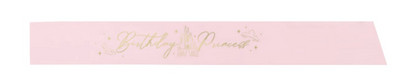 Pink Disney Princess birthday sash with gold “Birthday Princess” lettering, castle artwork, and star accents.