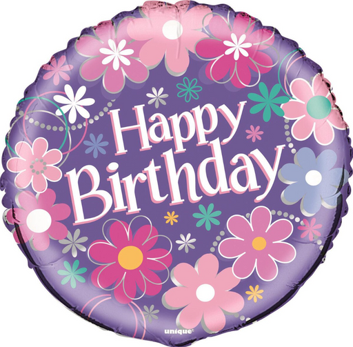 A round foil balloon with a purple background decorated with colorful floral patterns and the words 'Happy Birthday' in large white letters with a pink outline. The brand name 'unique' is printed at the bottom.
