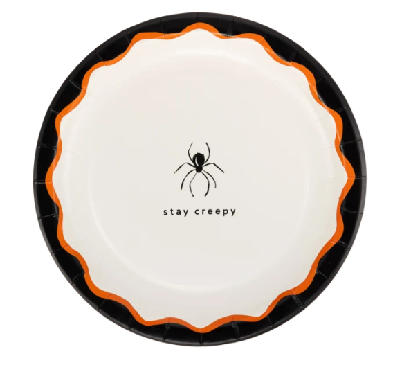 A round paper plate with a scalloped edge, featuring a black spider graphic and the text 'stay creepy' in black on a white center, bordered by a bright orange stripe and a black rim.