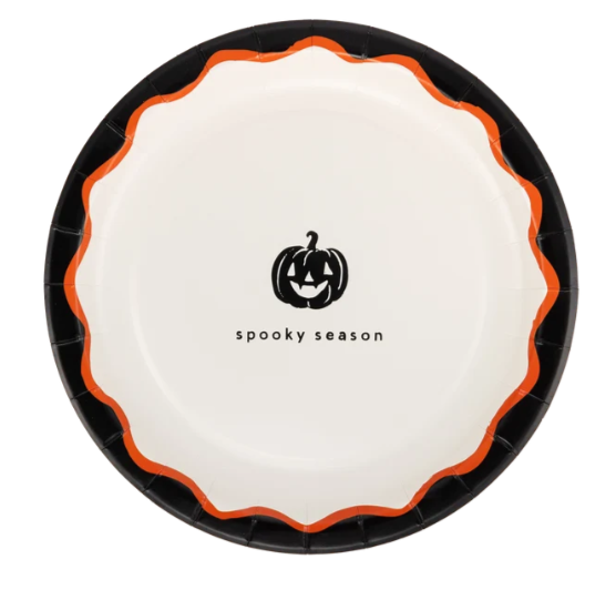 A round paper plate with a black rim, an orange scalloped inner rim, and a white center featuring a black jack-o'-lantern graphic and the text 'spooky season'.