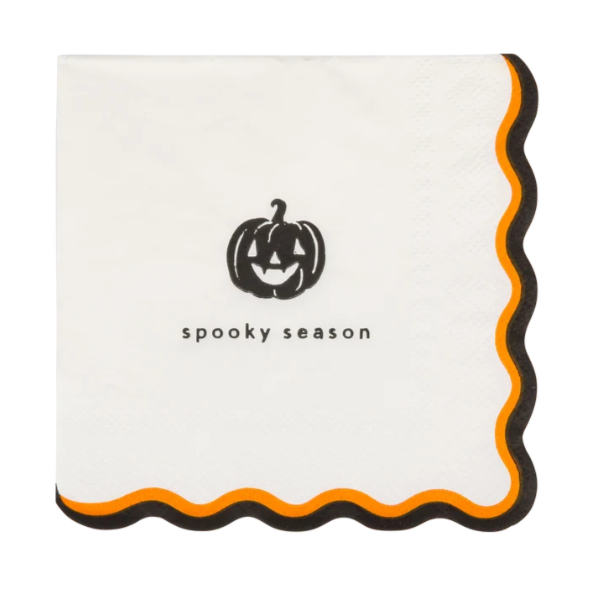 A square white paper napkin with scalloped edges, featuring a black jack-o'-lantern graphic and the text 'spooky season' in the center, with an orange and black scalloped border.