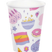 A white paper party cup decorated with a colorful, playful pattern of pink bunnies, a bowl of popcorn, a pink donut, a rainbow-striped pillow, and small stars and hearts.