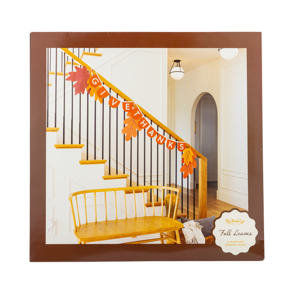 Decorative 'GIVE THANKS' banner on a staircase with fall leaves, framed by a brown border.