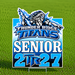 A custom die-cut yard sign featuring the Thunder Ridge Titans logo and the text 'SENIOR 2T 27' in blue, white, and black, displayed on a metal stake in a green grass field.