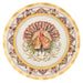 A round decorative plate featuring a central turkey illustration surrounded by ornate brown scrollwork and a wide gold rim on a white background.
