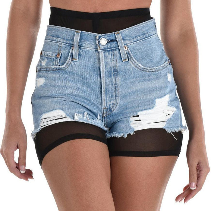 Light blue distressed denim shorts with rips and frayed edges paired with sheer black mesh bike shorts underneath.
