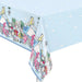 Light blue rectangular plastic tablecloth featuring Alice in Wonderland characters including Alice, the Mad Hatter, and Cheshire Cat surrounded by teacups, playing cards, and whimsical details in pink, green, and white.