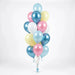 Alice in Wonderland-inspired balloon bouquet featuring pastel light blue, pink, pale yellow, and white latex balloons with curling ribbons.