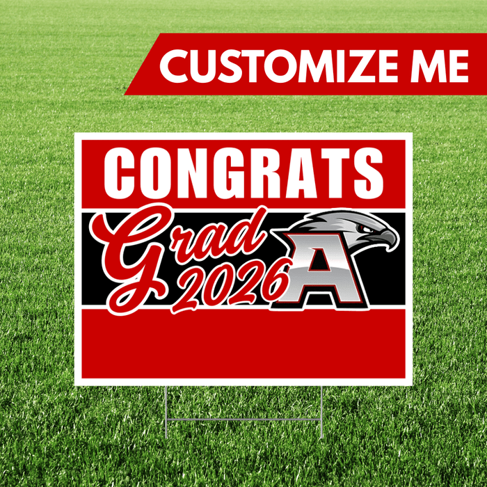 Graduation-themed sign with 'Congrats Grad 2026' on a grass background