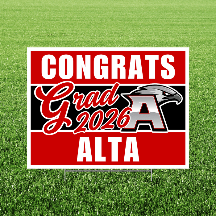 Red and black yard sign with white text reading "Congrats Grad 2026 Alta" and an eagle logo, displayed on green grass.