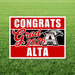 Red and black yard sign with white text reading "Congrats Grad 2026 Alta" and an eagle logo, displayed on green grass.