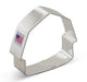 Silver metal barn-shaped cookie cutter with a small American flag label visible on the front of the cutter.