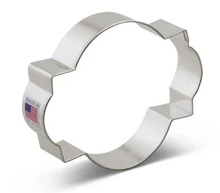 Stainless steel cookie cutter with scalloped flower petal edges and rectangular tab handles, displayed at an angle against a white background.