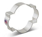 Stainless steel cookie cutter with scalloped flower petal edges and rectangular tab handles, displayed at an angle against a white background.