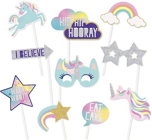 Ten pastel unicorn-themed photo booth props on sticks featuring rainbows, stars, clouds, unicorn faces, a flag saying "I Believe," and speech bubbles with text in pink, blue, yellow, and silver glitter.