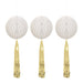 Three white honeycomb ball decorations with gold metallic tassel streamers hanging below each one.