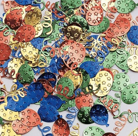 Colorful metallic confetti pieces in red, blue, green, gold, and cream featuring balloon and streamer designs scattered on a white surface.