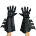 Pair of black Batman gauntlets with textured quilted palms, gray geometric patterns, and extended forearm cuffs with layered flaps, displayed on outstretched hands against a white background.