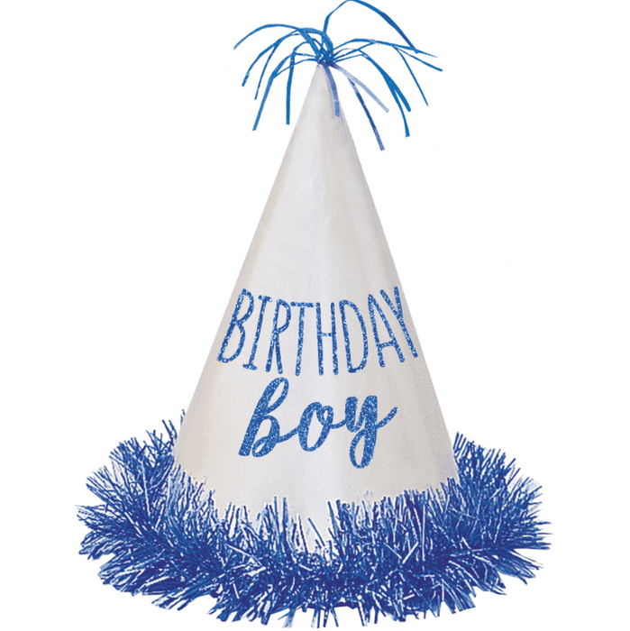 White cone-shaped party hat with blue "Birthday Boy" glitter text, topped with blue metallic fringe and brim trimmed in blue tinsel.