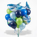 Shark-themed balloon bouquet featuring a large blue shark foil balloon at top, surrounded by lime green, light blue, dark blue, and royal blue latex balloons, with shark face foil balloons displaying "Happy Birthday" text throughout the arrangement.