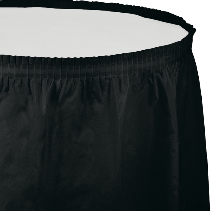 Black velvet tableskirt with elastic band waistline and vertical pleated panels along the bottom edge.