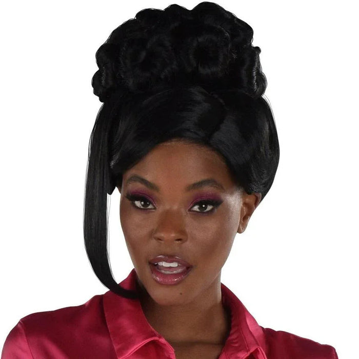 Black beehive updo hairpiece with clip-in side bangs and long straight ponytail extension, shown on a model with burgundy eyeshadow and red shirt against white background.