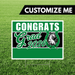 Graduation-themed sign with 'Congrats Grad 2026' on a grass background