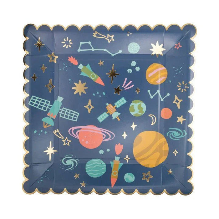 Square paper plates with a scalloped gold border featuring a navy blue background decorated with colorful illustrated planets, rockets, satellites, stars, and celestial objects in gold, yellow, pink, and teal.