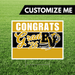 Graduation-themed customizable sign with 'Congrats Grad 26' text on a grass background