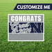 Graduation-themed customizable sign with 'Congrats Grad 2026' text on a grass background