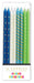 Sixteen tall tapered candles in blue, white, teal, and green with gold patterns including stars, stripes, and dots, each with a decorative candle holder base.