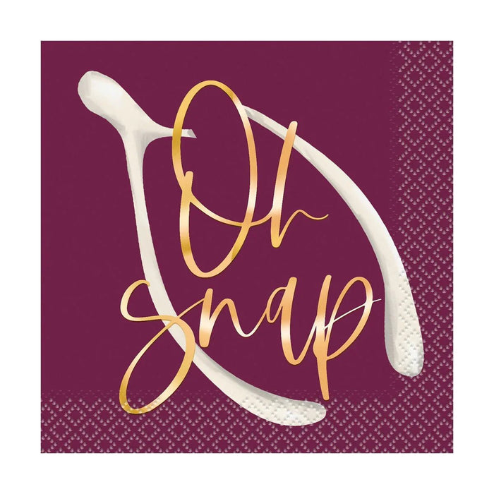 Burgundy napkins with white utensil illustrations and gold script reading "Oh Snap" in the center.