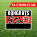 Graduation-themed customizable sign with 'Congrats Grad 2026' text on a grass background