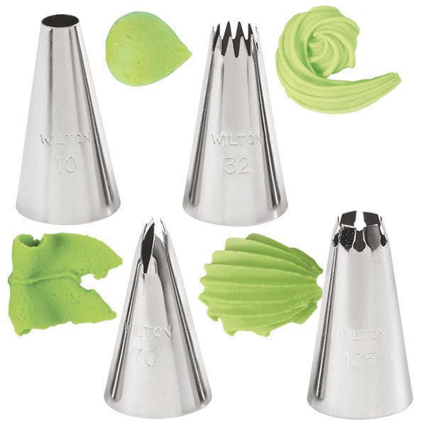 Four stainless steel piping tips with varying designs displayed alongside green frosting samples showing the patterns each tip creates.