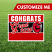 Graduation-themed sign with 'Congrats Grad 2026' on a grass background