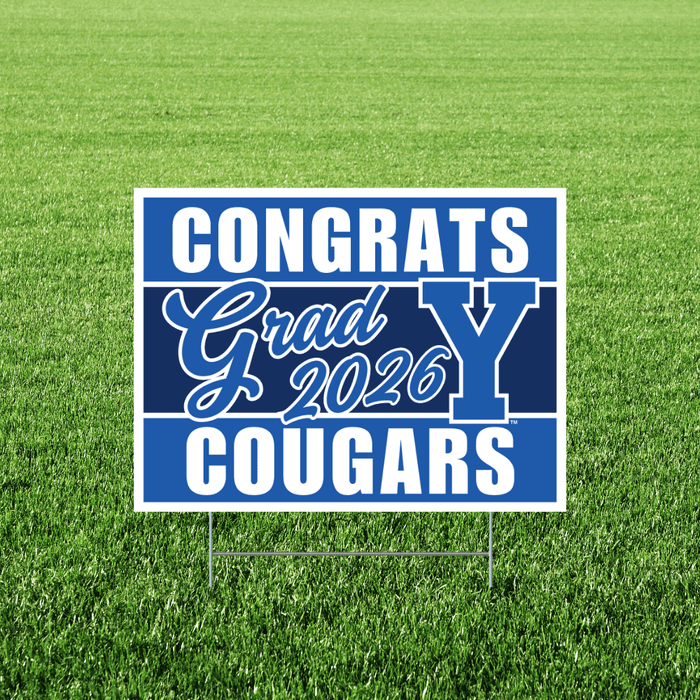 Blue and white yard sign with "CONGRATS Grad 2026 COUGARS" text and BYU logo displayed on green grass.