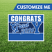 Graduation-themed sign with 'Congrats Grad 2026' on a grass background