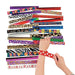 Child's hands wearing and holding colorful patterned slap bracelets in designs including leopard print, zebra stripes, smiley faces, hearts, polka dots, and floral patterns among approximately 50 assorted bracelets displayed fanned out.
