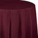 Deep burgundy round plastic tablecloth with draped fabric texture and pleated edge detail against a white background.