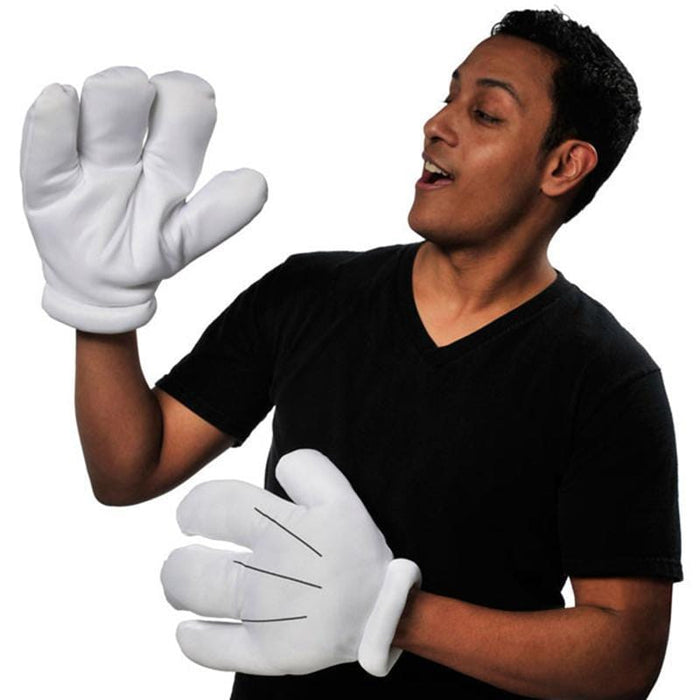 White oversized cartoon gloves with rounded fingers displayed on a man wearing a black v-neck shirt against a white background.